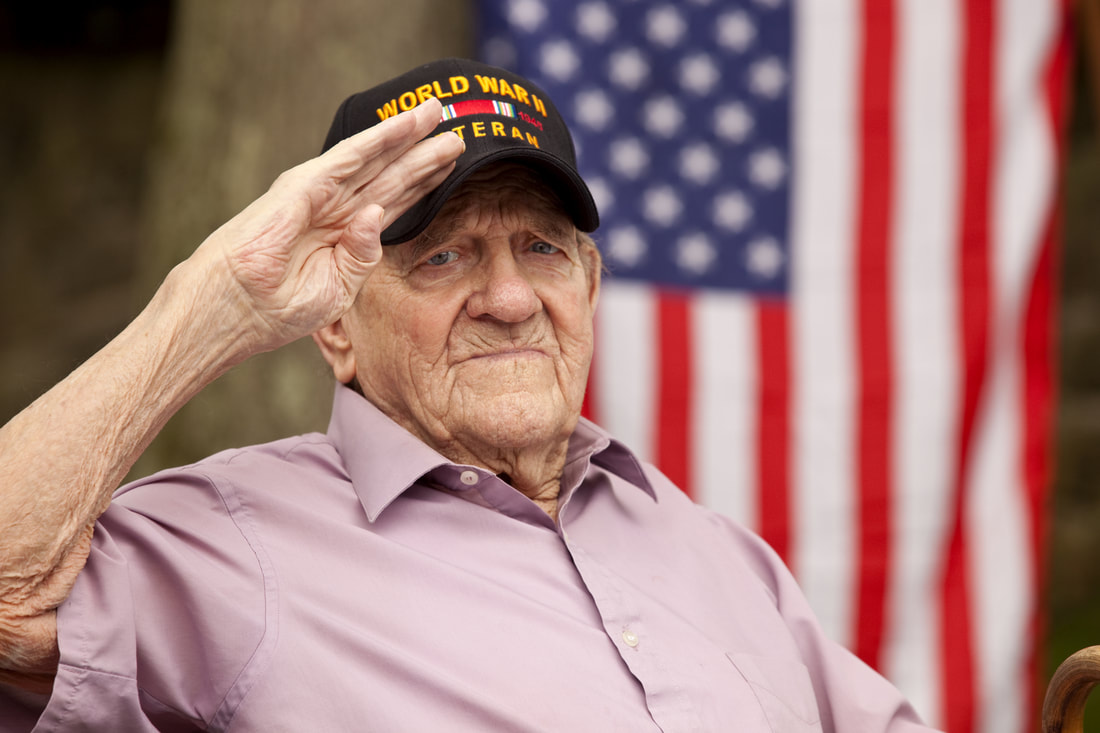 World War II veteran saluting in front of an American flag